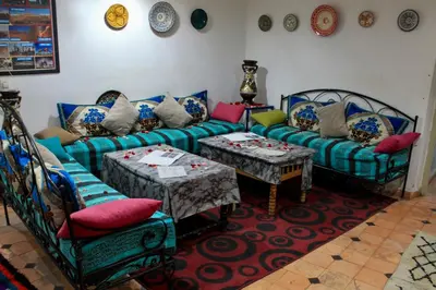 a living room with a couch and two tables at Hostel kif kif annex in Marrakech
