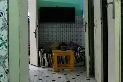 a room with a couch with a table in it at Hostel kif kif annex in Marrakech