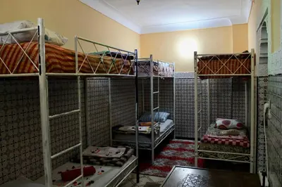 a room with three bunk beds in a room at Hostel kif kif annex in Marrakech