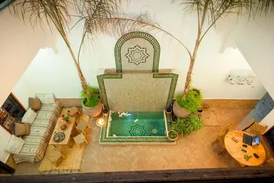 an overhead view of a living room with a chair and a pool at Riad Dar Jdati in Marrakech