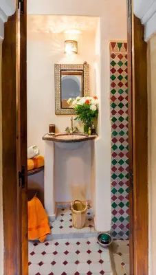 a bathroom with a sink and a mirror at Riad Dar Jdati in Marrakech