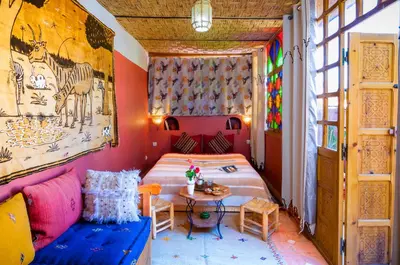 a bedroom with a bed and a table in a room at Riad Dar Jdati in Marrakech