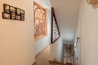 a hallway with a window and a tile floor at Riad Dar Jdati in Marrakech