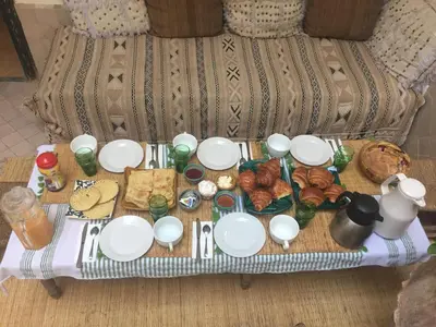 a table with plates and food on a couch at Riad Dar Jdati in Marrakech