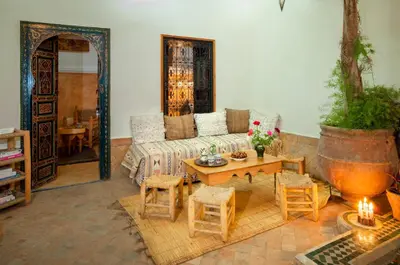 a living room with a couch and a table at Riad Dar Jdati in Marrakech