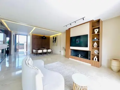a living room with a white couch and a tv at LUXURY Villa Argane 5 BDR -ONLY FAMILYS in Marrakech