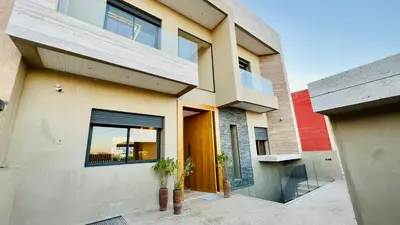 a house with a large window and a building at LUXURY Villa Argane 5 BDR -ONLY FAMILYS in Marrakech