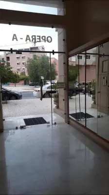a glass door of a building with aania sign on it at Chic & Cosy au coeur d’hivernage in Marrakech