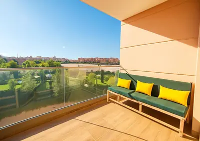 a green couch in a room with a large window at Pearl Garden 69 in Marrakech
