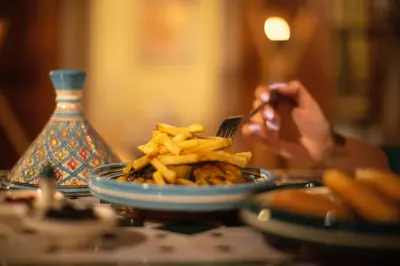a person taking a picture of a plate of fries at Riad Chez Henriette in Marrakech