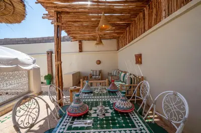 a dining room with a table with vases on it at Riad Chez Henriette in Marrakech