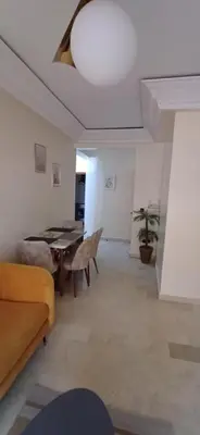 a living room with a table and a couch at AL ANDALOUS 6 - une chambre in Marrakech