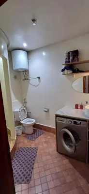 a bathroom with a toilet and a washing machine at AL ANDALOUS 6 - une chambre in Marrakech