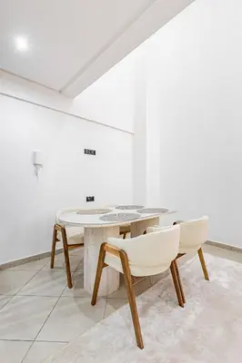 a white room with a table and two chairs at New! Duplex de Luxe, Cocon de Confort in Marrakech