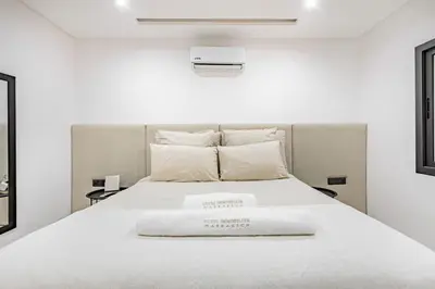 a bedroom with a white bed with white sheets and pillows at New! Duplex de Luxe, Cocon de Confort in Marrakech