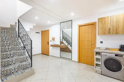 a laundry room with a washer and dryer and a staircase at New! Duplex de Luxe, Cocon de Confort in Marrakech