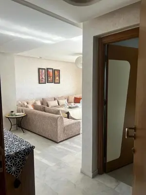a living room with a couch and a table at LUXURY APPART Pool view Riad Garden in Marrakech