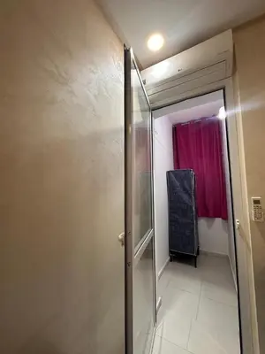 a bathroom with a shower and a red curtain at Charmant Appartement 2 Chambres pour Sejours en Famille Marrakech in Marrakech
