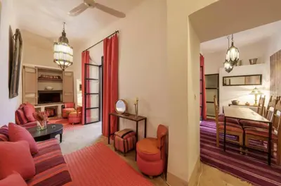 a living room with a couch and a table at Riad Slima - riad privatisé -Marrakech au coeur de la médina 1 Acheminement compris Aéroport riad in Marrakech