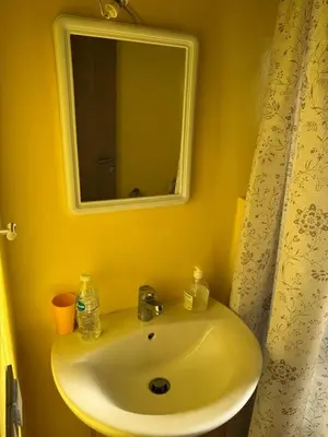 a yellow bathroom with a sink and a mirror at A1, Central, Old-City 7Min on feet, good equipped in Geliz, Bab-Dokala, Majorelle, No taxi needed in Marrakech
