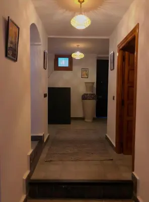 a hallway with a room with a door and a rug at Riad Orient Palace in Marrakech