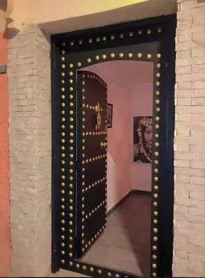 a large mirror in a room with a brick wall at Riad Orient Palace in Marrakech