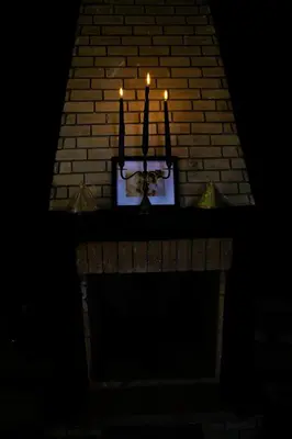 a brick fireplace with candles on it at night at Zine Villa Guest House in Marrakech