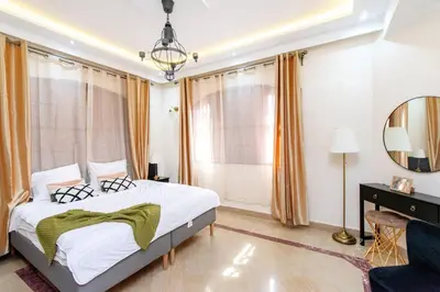 a bedroom with a bed and a mirror at Zine Villa Guest House in Marrakech