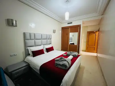 a bedroom with a large bed with red pillows at Chez Alex in Marrakech