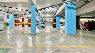 an empty parking lot with blue columns in a parking garage at Chez Alex in Marrakech