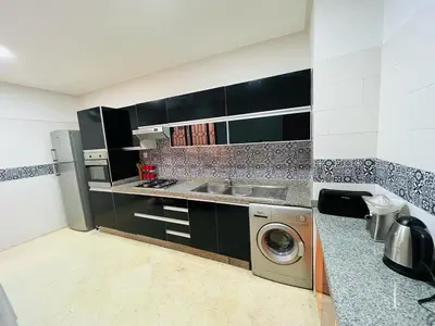 a kitchen with a washer and a washing machine at Chez Alex in Marrakech