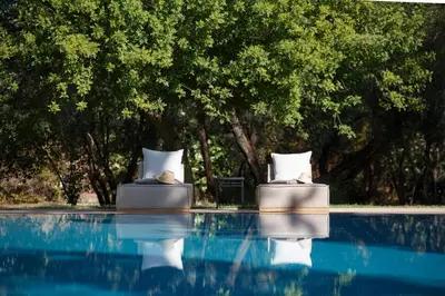 two chairs sitting next to a swimming pool at Maggy Rose in Marrakech