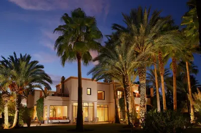 a house with palm trees in front of it at Maggy Rose in Marrakech