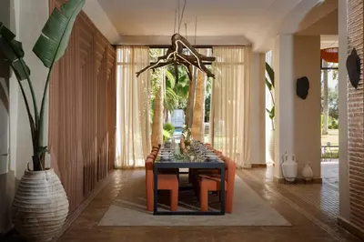 a dining room with a table and chairs in a room at Maggy Rose in Marrakech