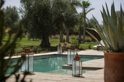 a swimming pool with several lights in a park at Villa MISH-MISH in Marrakech