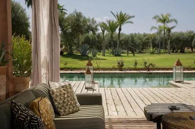 a living room with a couch and a pool at Villa MISH-MISH in Marrakech