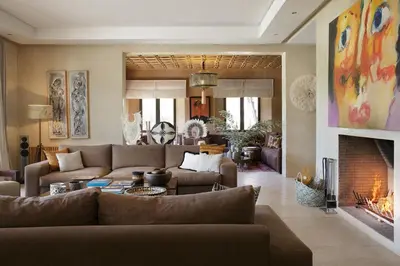 a living room with a couch and a fireplace at Villa MISH-MISH in Marrakech