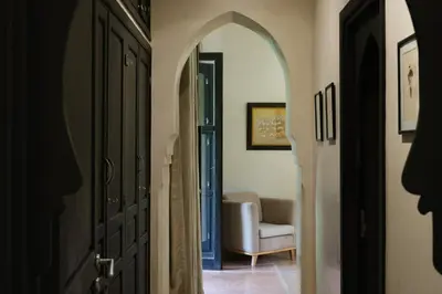 a hallway with an archway and a chair in a room at Villa Jennabelle in Marrakech
