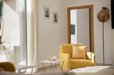 a living room with a yellow chair and a table at Villa PEPE in Marrakech