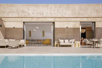 a patio with a swimming pool next to a house at Villa PEPE in Marrakech