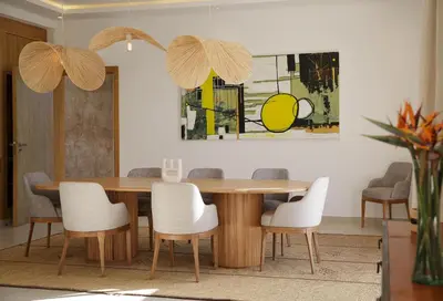 a dining room with a wooden table and chairs at Villa PEPE in Marrakech