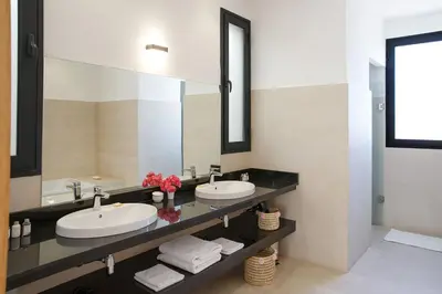a bathroom with two sinks and a large mirror at ADA ADA modern villa with heated private pool next city center in Marrakech