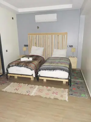 two beds sitting next to each other in a bedroom at B1 In Center of Marrakech, Geliz-Majorelle, Bab-Dokala, No need for Taxi in Marrakech