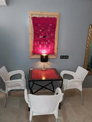 a room with chairs and a table and a painting at B1 In Center of Marrakech, Geliz-Majorelle, Bab-Dokala, No need for Taxi in Marrakech