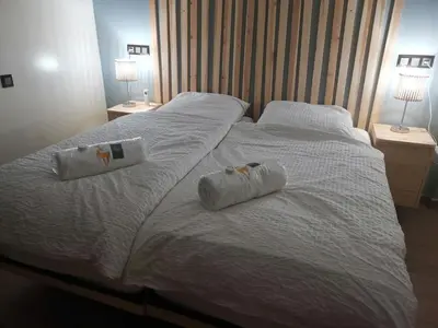 a white bed with two rolled towels on it at B1 In Center of Marrakech, Geliz-Majorelle, Bab-Dokala, No need for Taxi in Marrakech