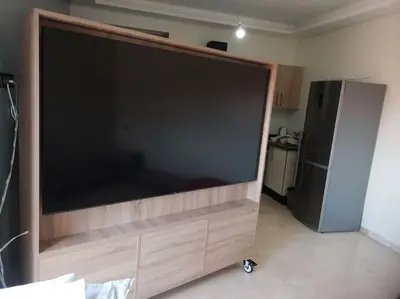 a large screen television in a kitchen with a refrigerator at B1 In Center of Marrakech, Geliz-Majorelle, Bab-Dokala, No need for Taxi in Marrakech