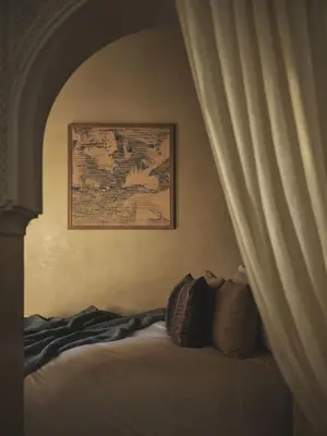 a bedroom with a bed with a picture on the wall at IZZA Marrakech in Marrakech