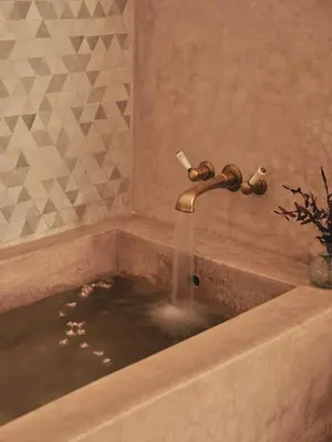 a bathroom sink with water coming out of a faucet at IZZA Marrakech in Marrakech