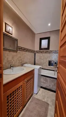 a bathroom with a sink and a tub at Appartement paisible et abordable Palmeraie Marrakech in Dar Caïd Layadi