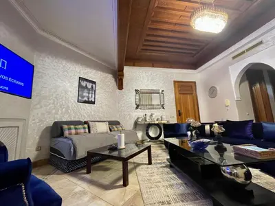a living room with a couch and a table at Au Temps Des Fleurs - Marrakech in Marrakech